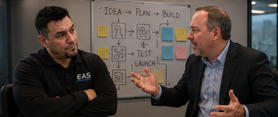 Jade Chancey and Tim Calabro working through a plan at the whiteboard