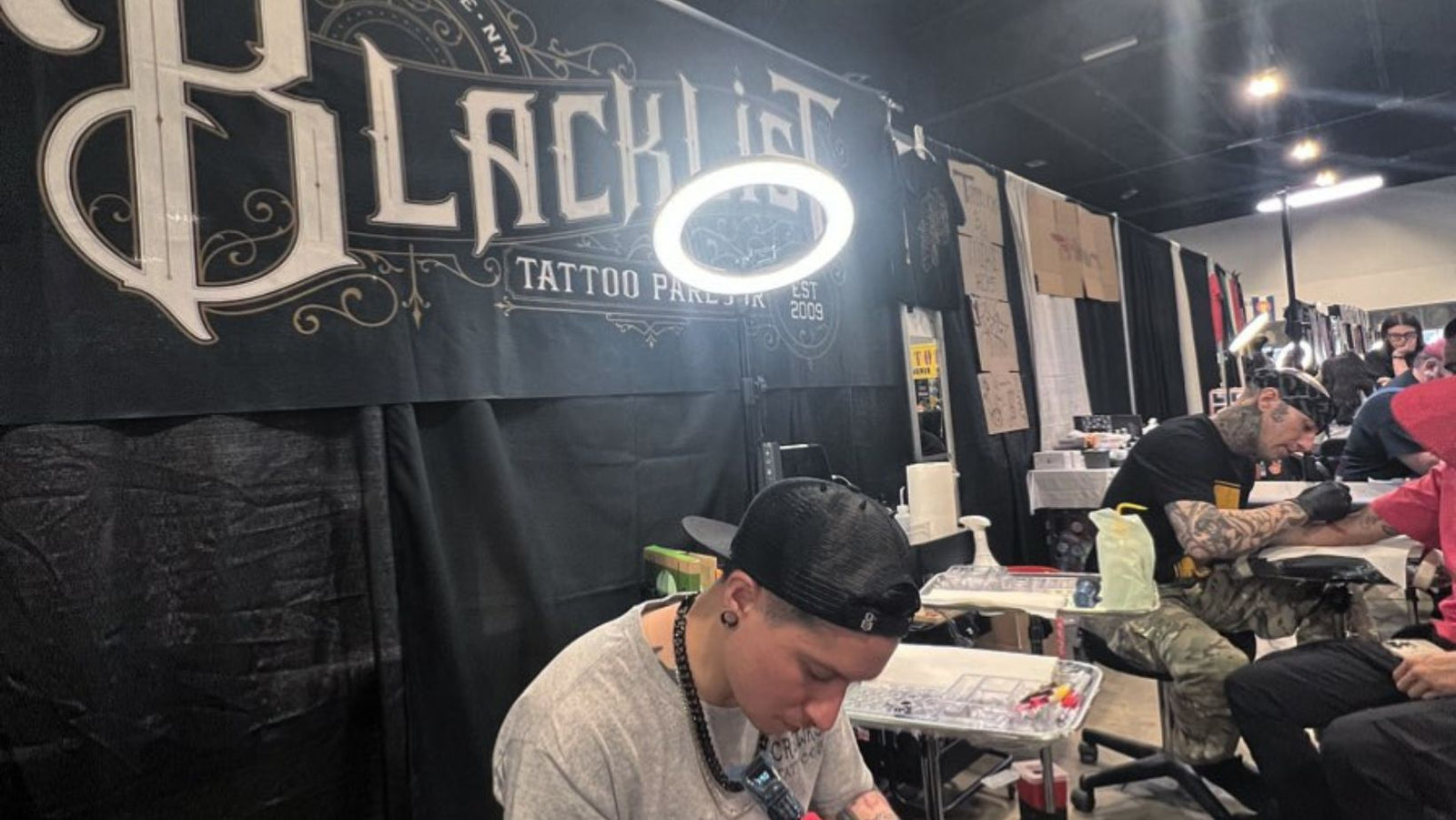 Blacklist Tattoo Parlour artists tattooing clients at a live convention
