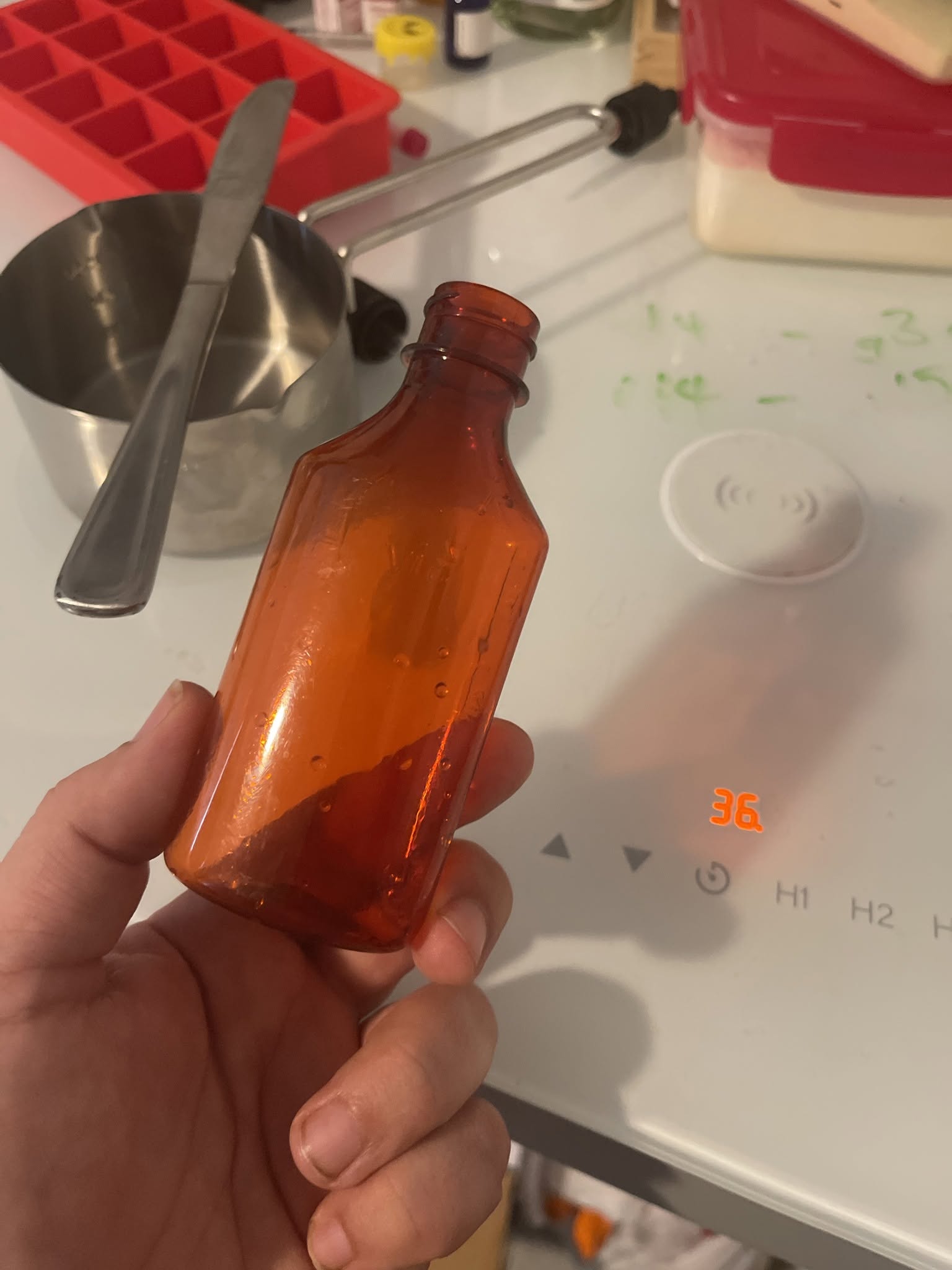 Small formulation bottle being inspected at a working bench