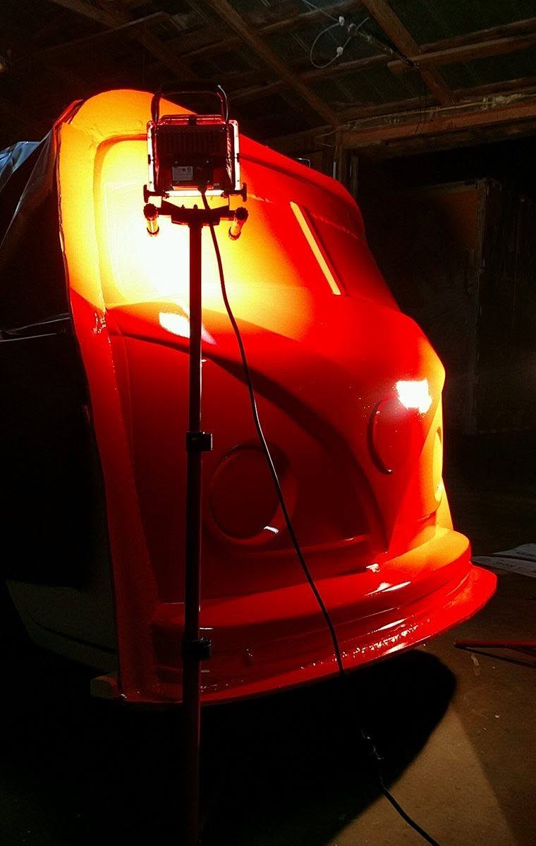 Fluffy Volkswagen monster-truck body illuminated during fabrication inside the workshop