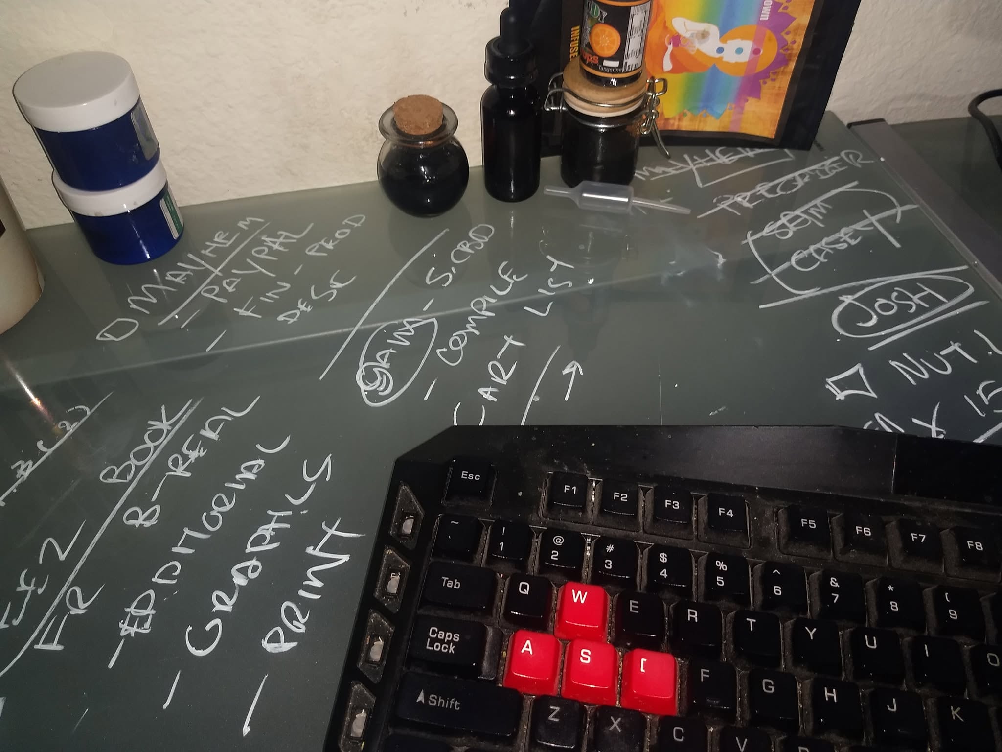 Handwritten system notes and electronics arranged together on a workbench